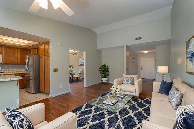 a living room with furniture and wooden floor