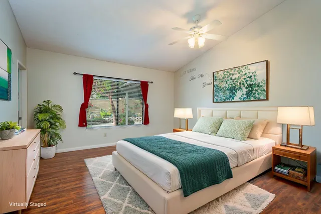 a bedroom with a large bed potted plant and a window