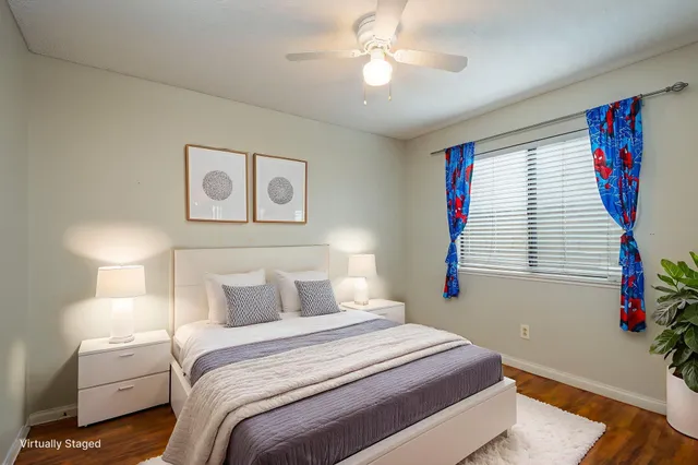 a bedroom with a large bed and a chandelier