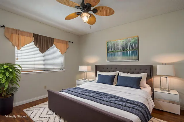 a bedroom with a bed and a potted plant