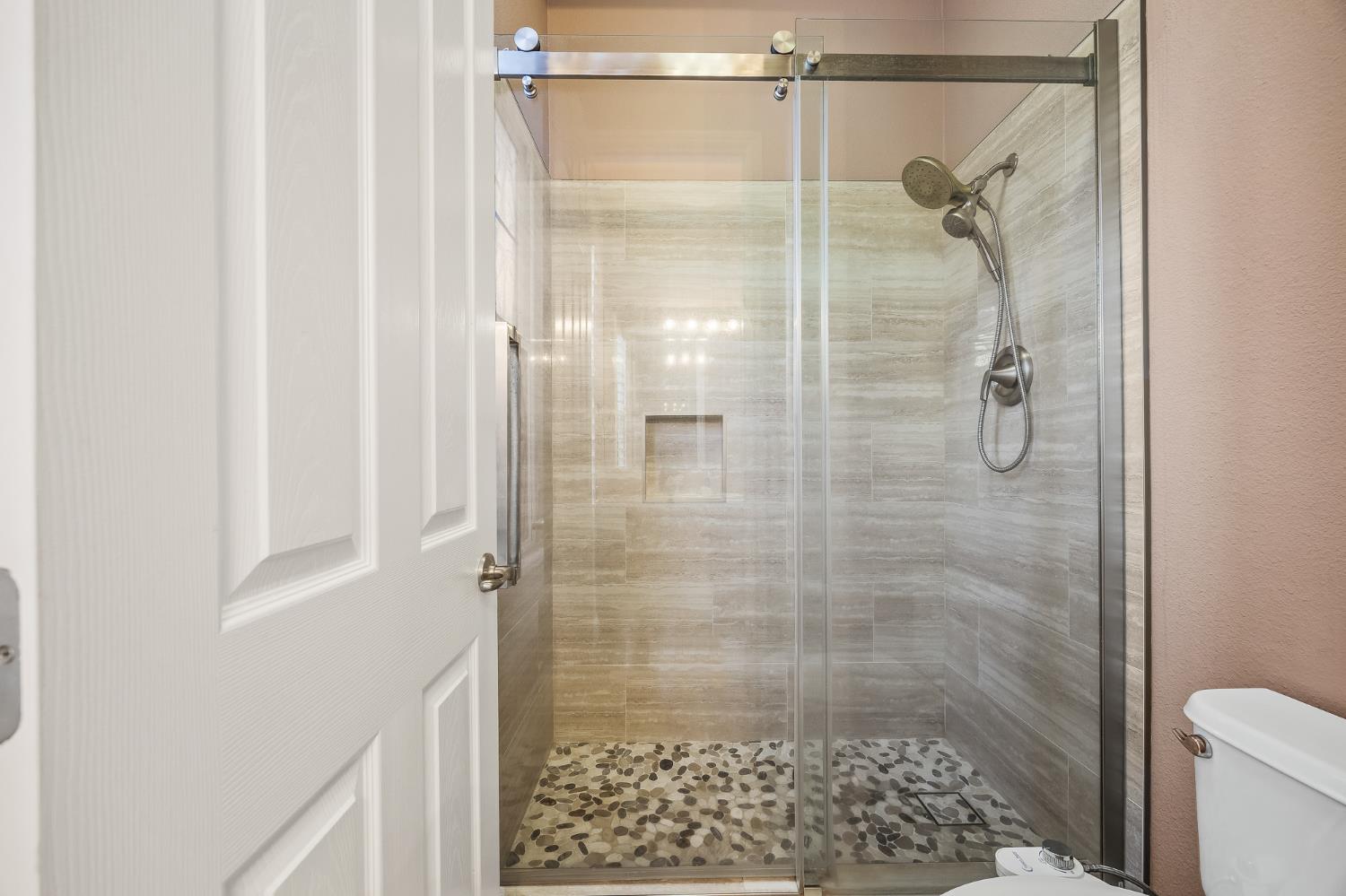 4183 North Bodega Bay Road Clovis, CA 93619 - Photo 21 of 30 a bathroom with a glass shower door