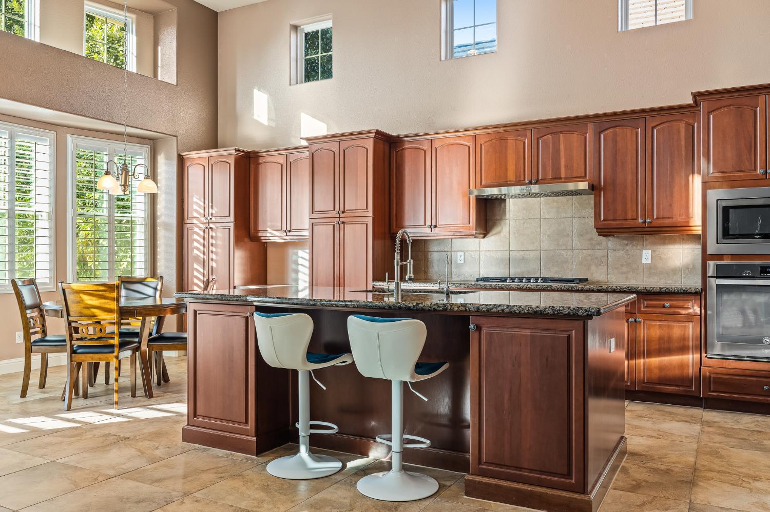 4183 North Bodega Bay Road Clovis, CA 93619 - Photo 7 of 30 a kitchen with a table chairs stove and cabinets