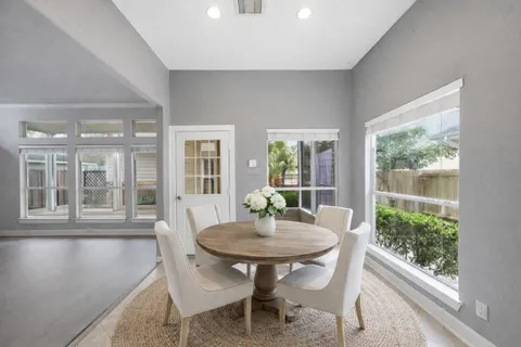 a view of a dining room with furniture window and outside view