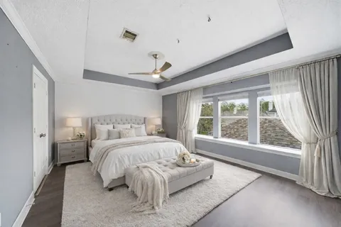 a bedroom with a large bed and a large window