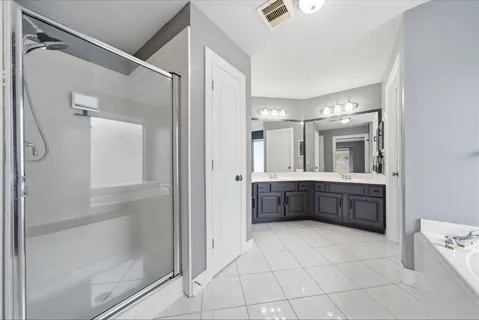 a bathroom with a mirror a double vanity sink and mirror