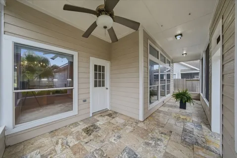 a view of interior space with wooden floor and a ceiling fan