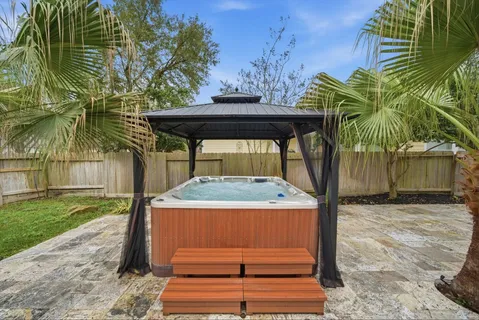 a view of a yard with plants and a fountain