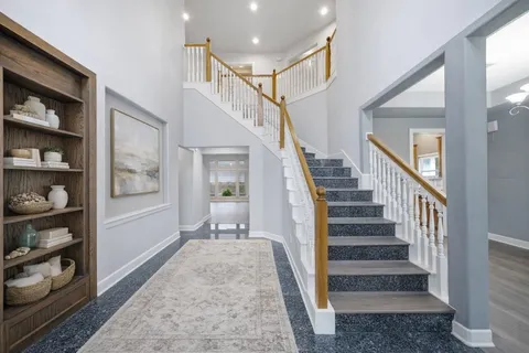 a view of entryway and hall with a rug