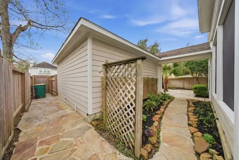 a backyard of a house with garden and plants