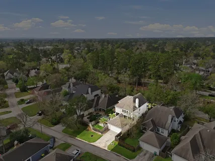 an aerial view of a house with a yard