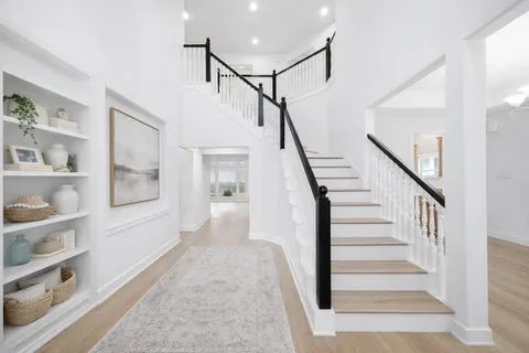 a view of staircase with white walls and windows