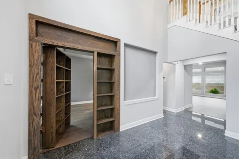 a view of an empty room with kitchen