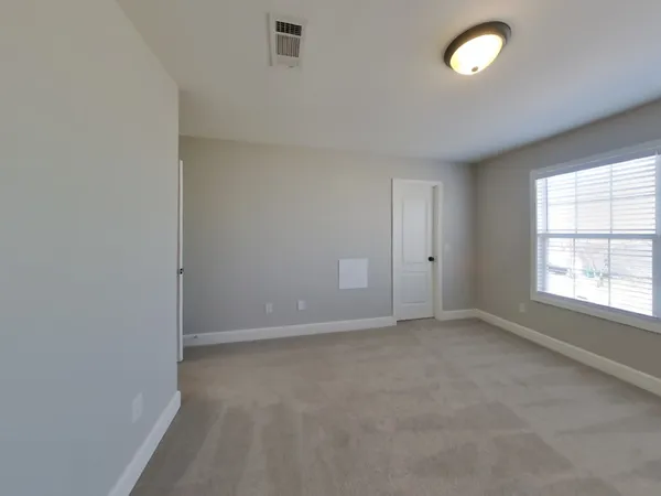 a bathroom with a granite countertop sink a toilet and mirror