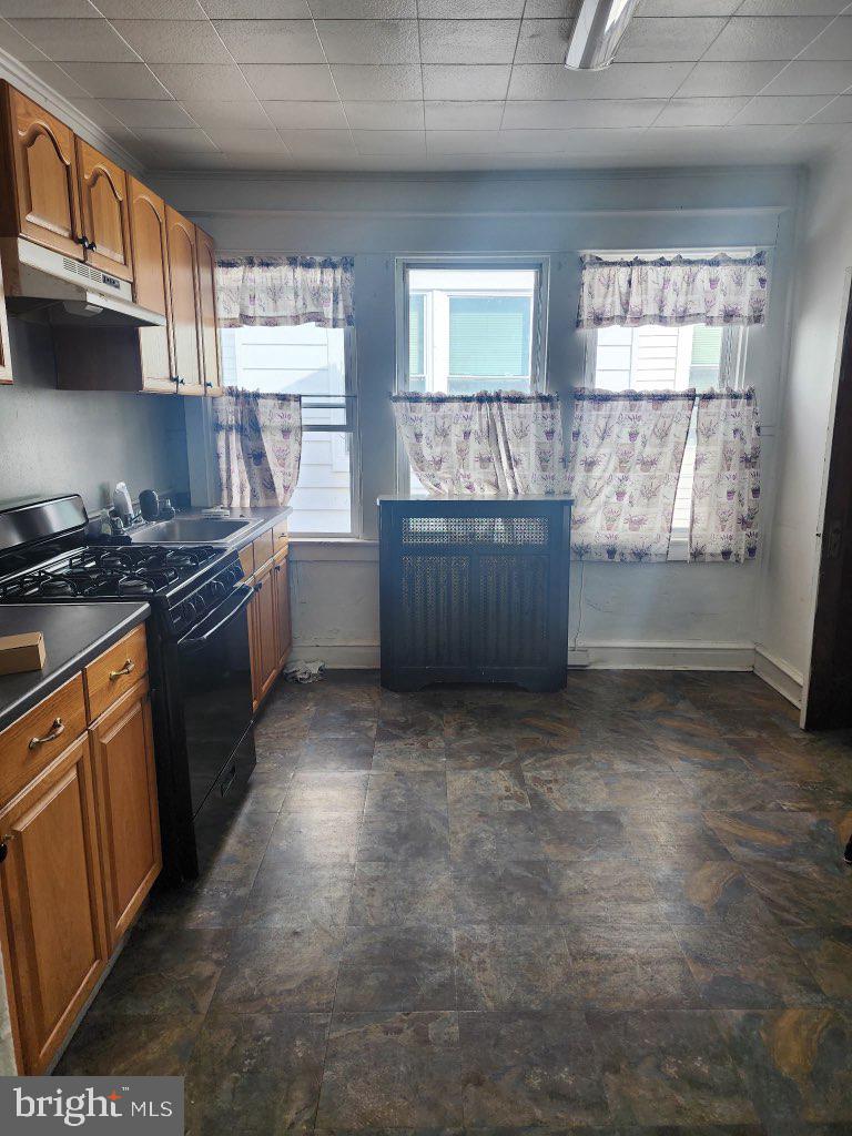 7323 Rising Sun Avenue, Unit 2 Philadelphia, PA 19111 - Photo 2 of 6 a kitchen with granite countertop a stove a sink and dishwasher