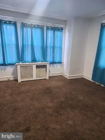 a view of an empty room with a wooden door