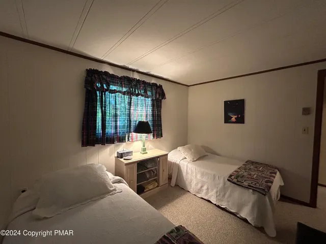 a bedroom with bed and a window