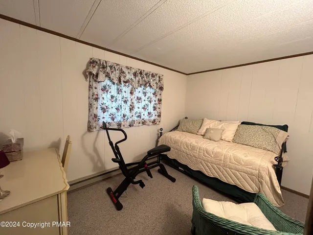 a bedroom with a bed and a desk