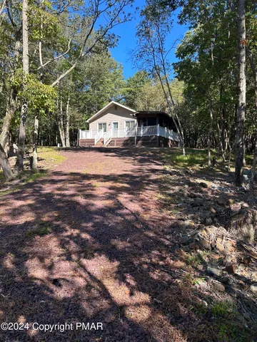 a yellow and red house sitting next to a road