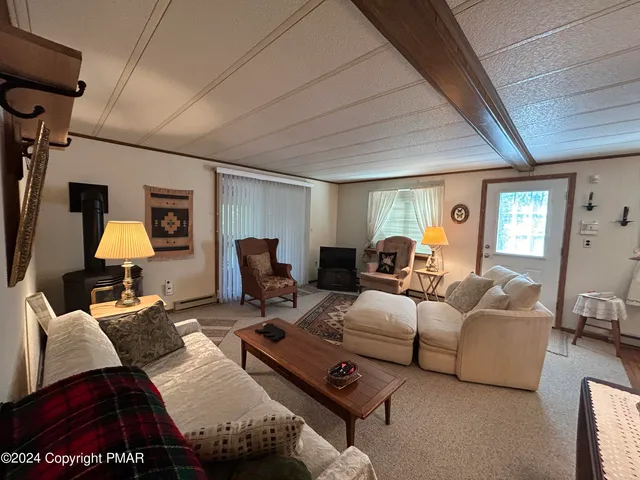 a living room with furniture a lamp and a window