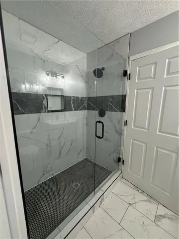 a bathroom with a shower and a mirror