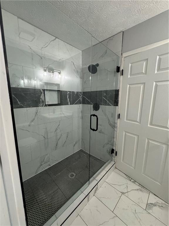 2911 Highpoint Road Snellville, GA 30078 - Photo 11 of 28 a bathroom with a shower and a mirror