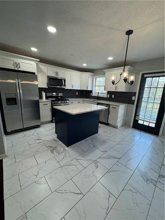 2911 Highpoint Road Snellville, GA 30078 - Photo 7 of 28 a large kitchen with kitchen island a stove a sink dishwasher and a refrigerator