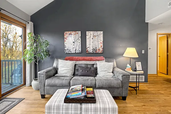 a living room with furniture and a lamp