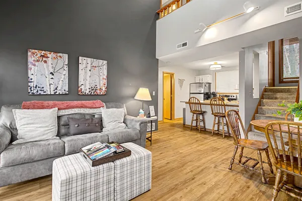a bedroom with furniture and a wooden floor