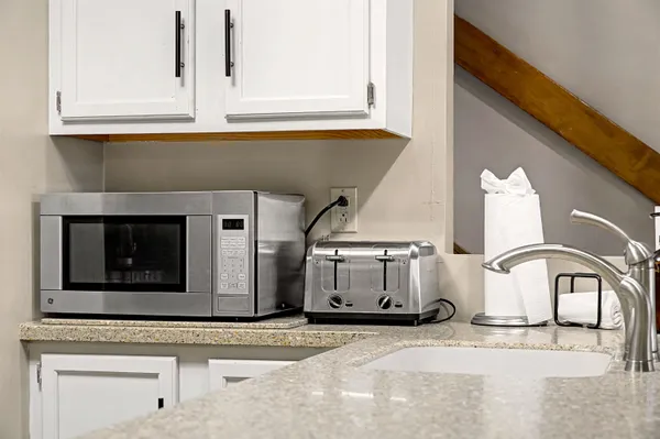 a kitchen with a sink and a microwave