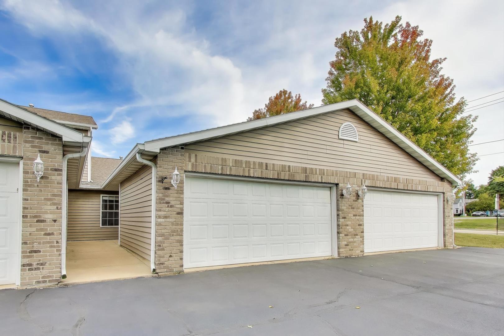 150 North Wooster Street, Unit 2 Capron, IL 61012 - Photo 1 of 17 a view of house with garage and small yard