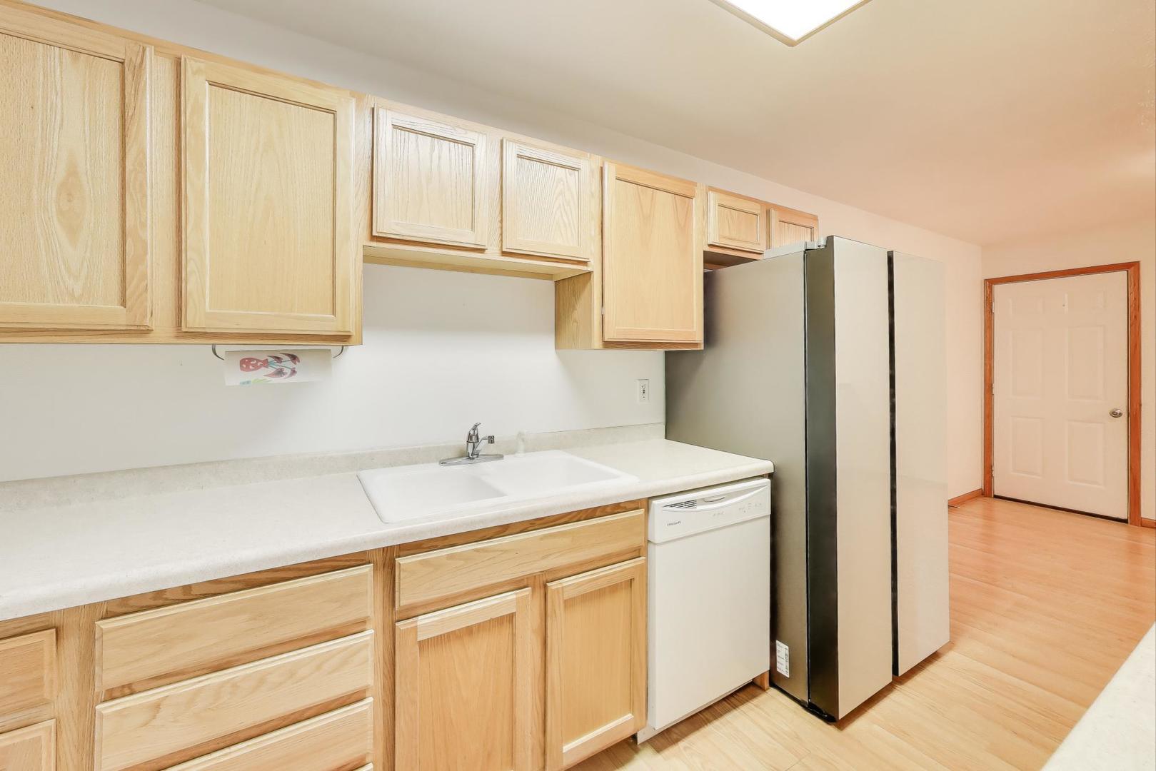 150 North Wooster Street, Unit 2 Capron, IL 61012 - Photo 5 of 17 a kitchen with a refrigerator sink and cabinets