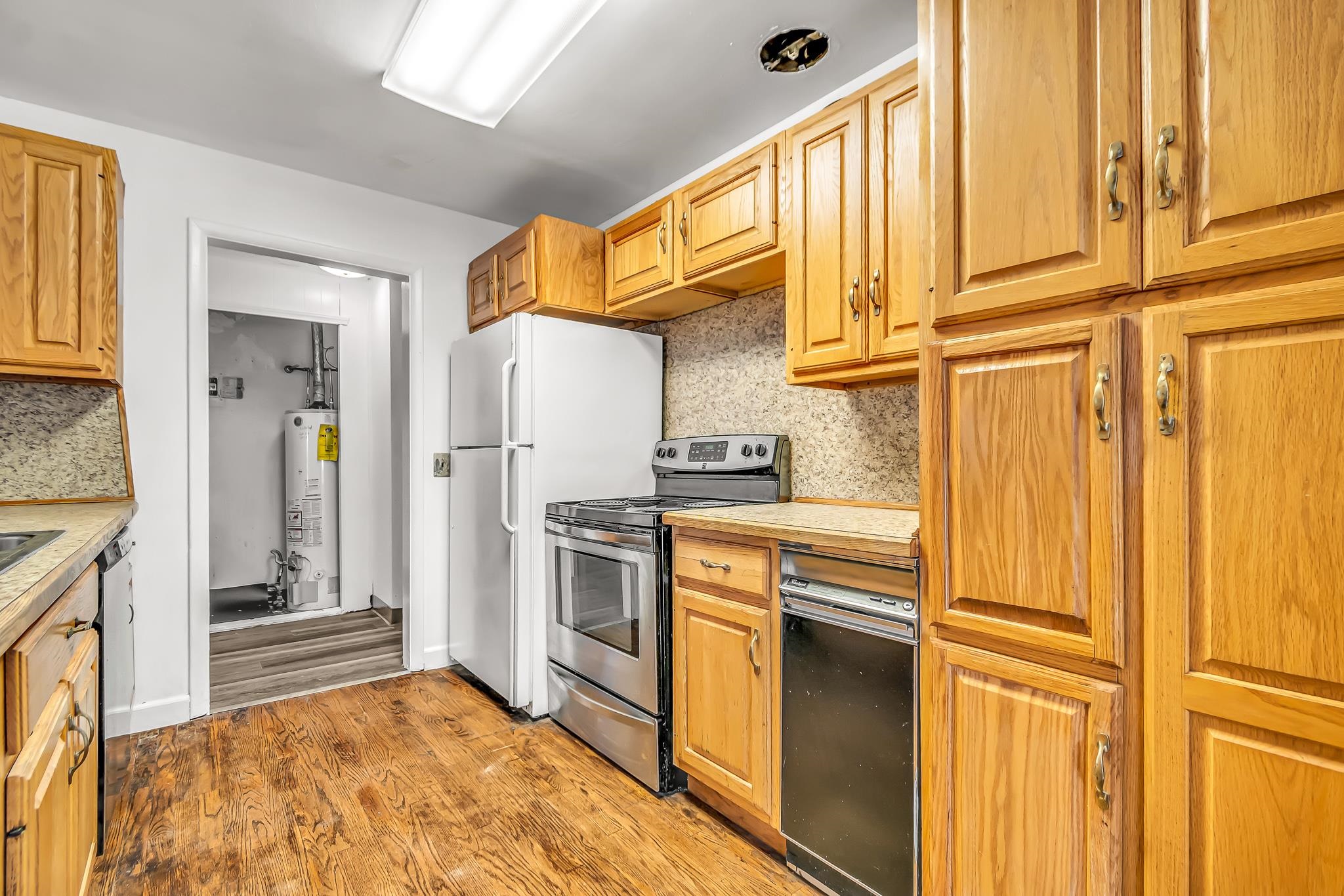 253 Nancy Street Grand Junction, CO 81503 - Photo 13 of 26 a kitchen with stainless steel appliances granite countertop a refrigerator and a stove