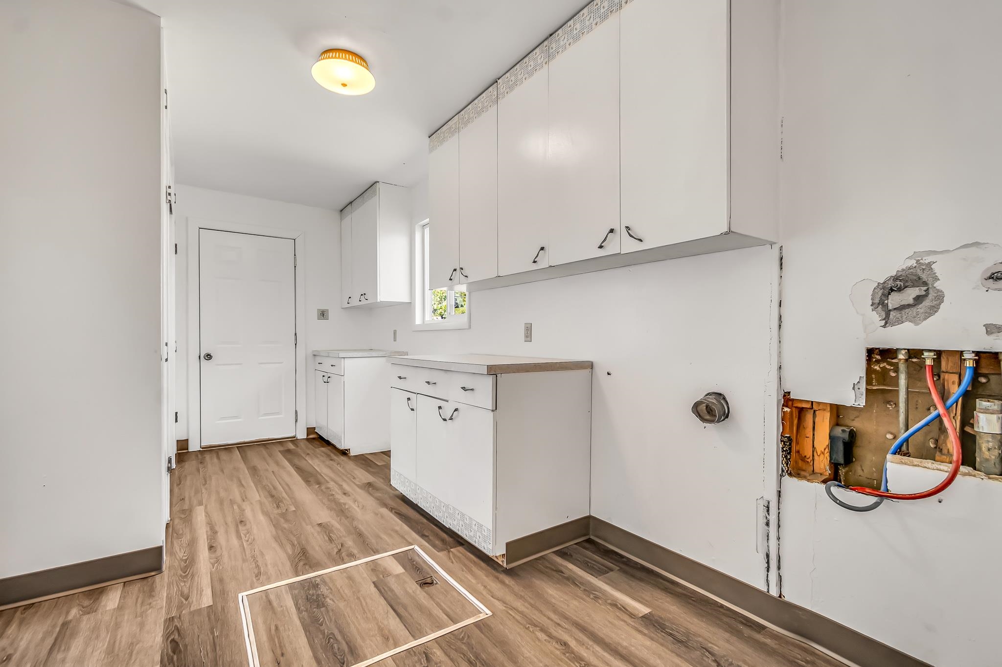 253 Nancy Street Grand Junction, CO 81503 - Photo 16 of 26 a kitchen with granite countertop a white cabinets and wooden floor