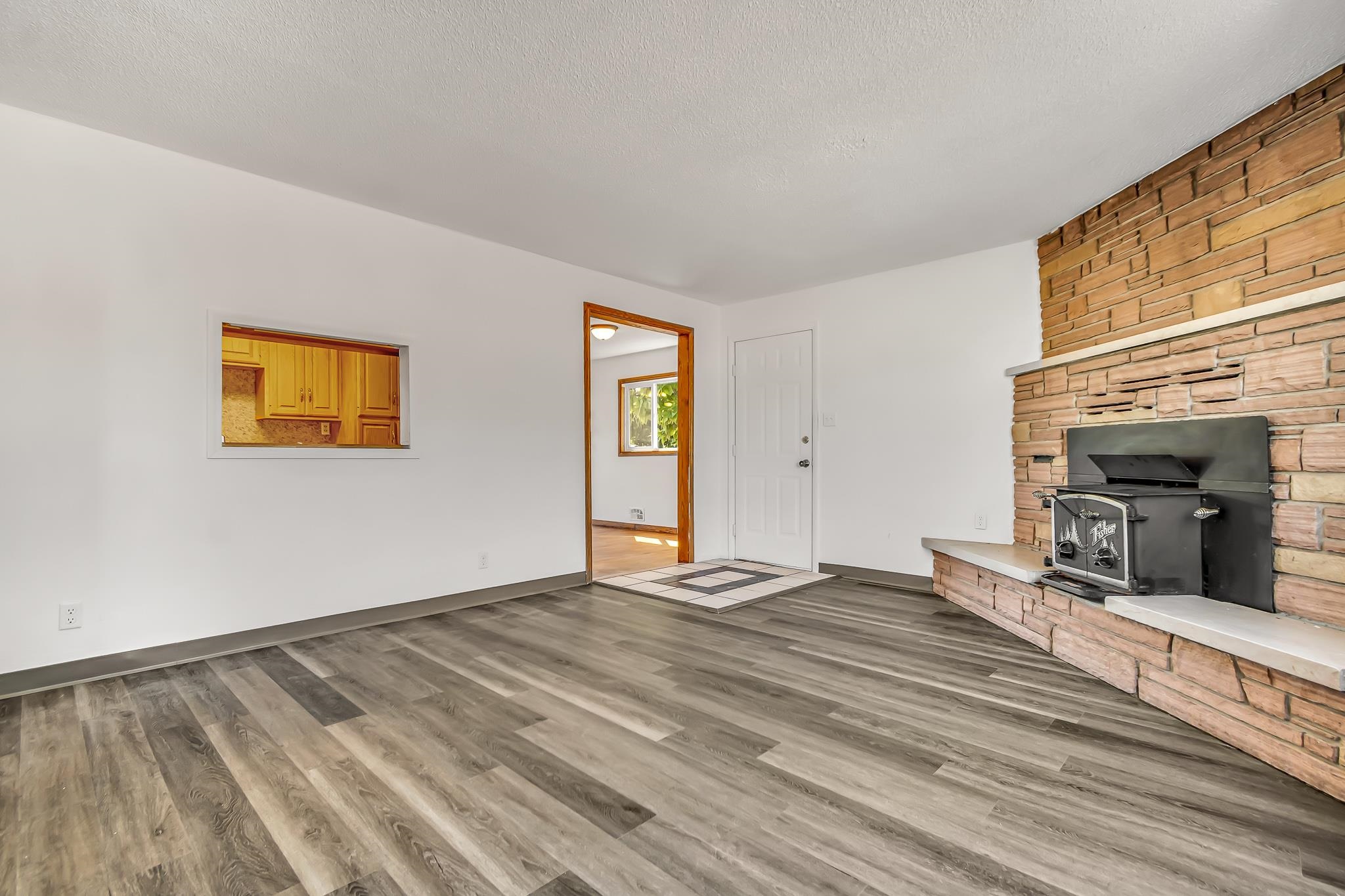 253 Nancy Street Grand Junction, CO 81503 - Photo 9 of 26 a view of a livingroom with wooden floor and a fireplace