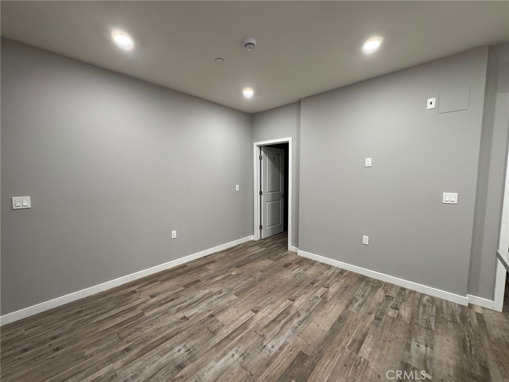 623 Normandie Avenue Los Angeles, CA 90004 - Photo 12 of 23 an empty room with wooden floor and windows