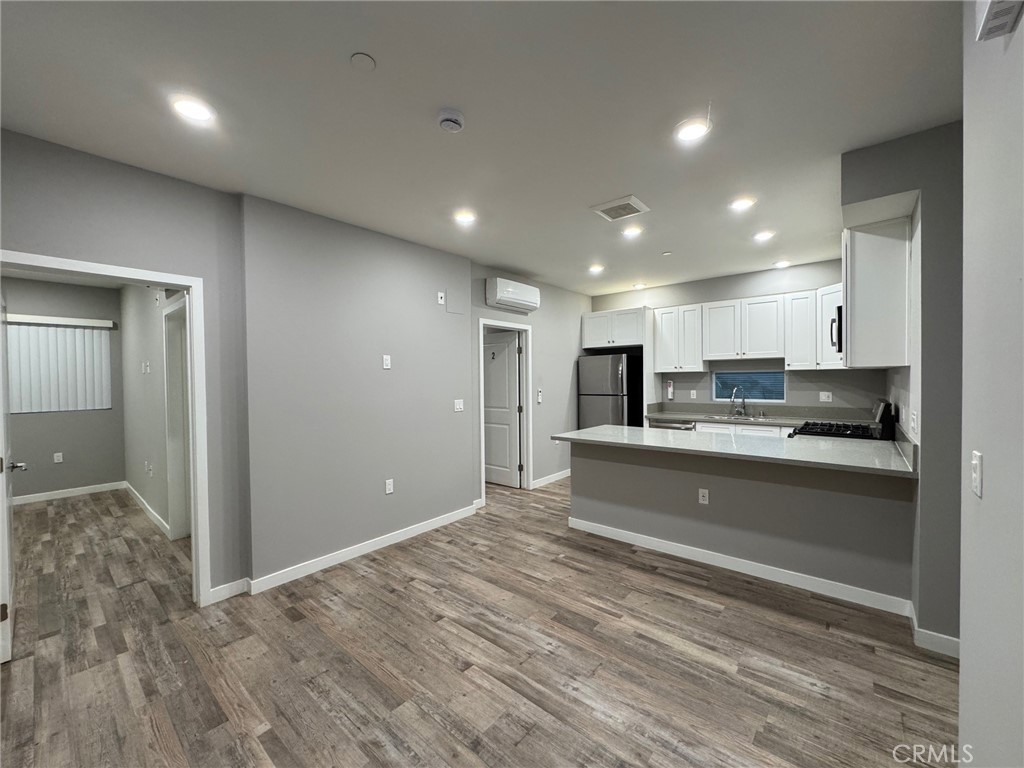 623 Normandie Avenue Los Angeles, CA 90004 - Photo 3 of 23 a large kitchen with kitchen island a sink stainless steel appliances and cabinets