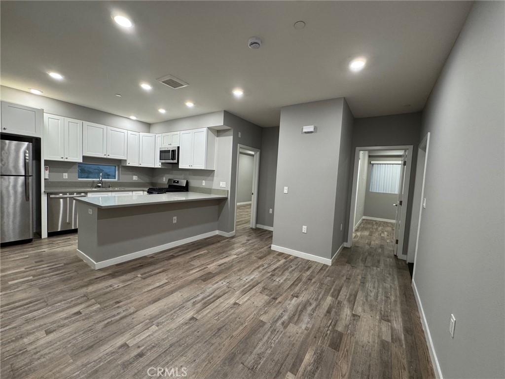 623 Normandie Avenue Los Angeles, CA 90004 - Photo 4 of 23 a kitchen with stainless steel appliances granite countertop a stove a sink and a refrigerator