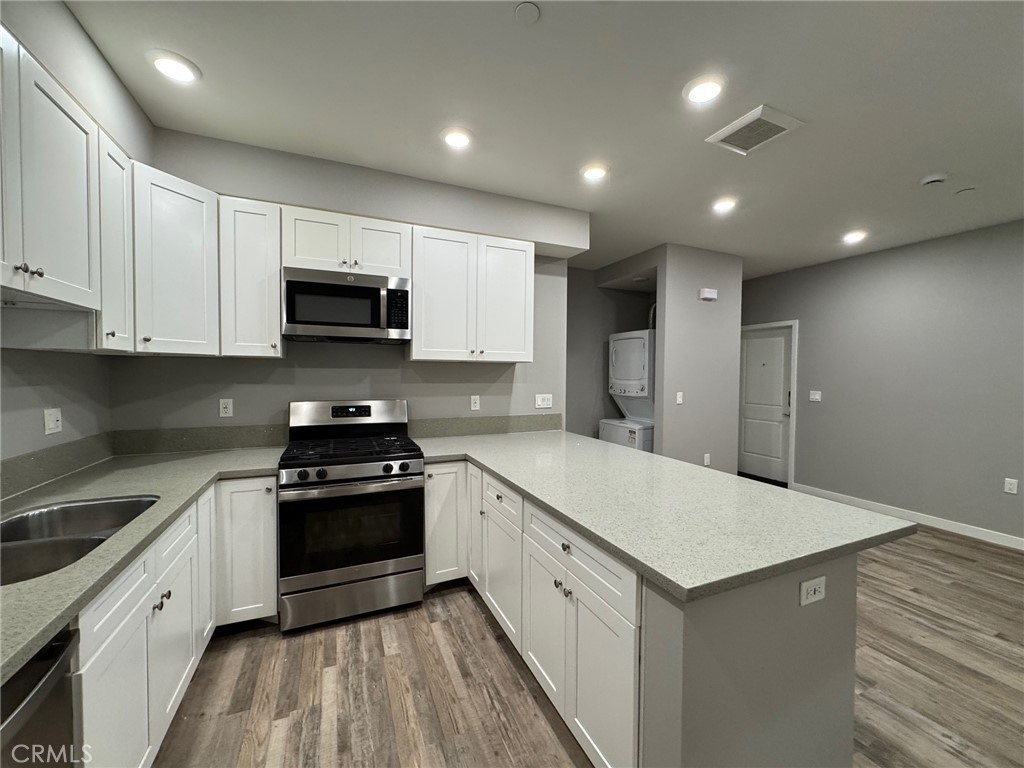 623 Normandie Avenue Los Angeles, CA 90004 - Photo 9 of 23 a kitchen with a sink stove and refrigerator