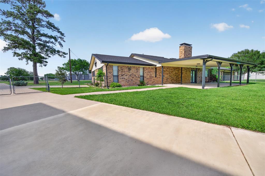 106 Snyder Ranch Road Trinidad, TX 75163 - Photo 33 of 40 Huge covered patio looks out to the back yard plus more parking behind the gate.