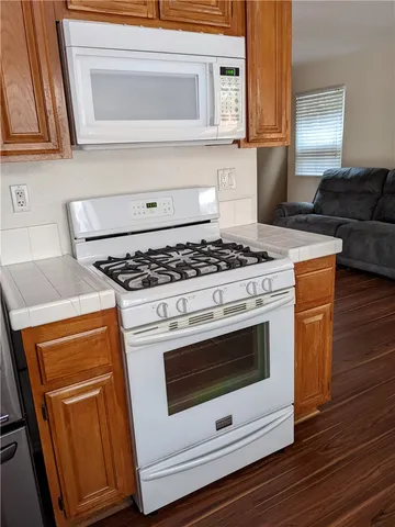 a stove top oven sitting inside of a kitchen