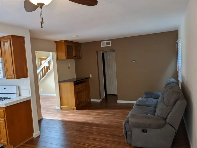 a living room with furniture window and wooden floor
