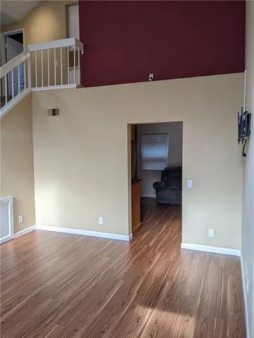 a view of a room with wooden floor