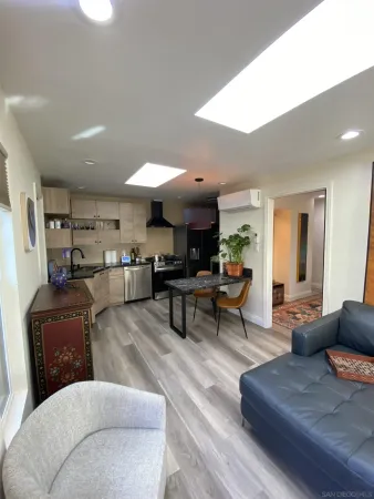 a living room with furniture and view of kitchen