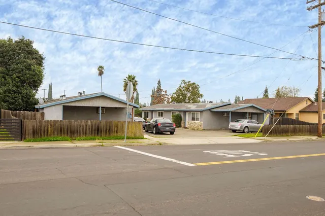 a view of a yard with wooden fence