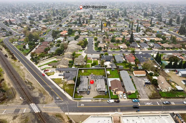 an aerial view of residential houses with city view
