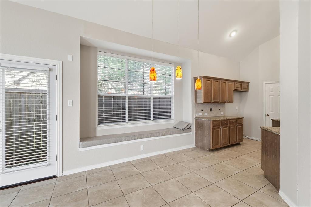 103 Ranch Trail Irving, TX 75063 - Photo 10 of 39 Breakfast area has sit down window ledge seating and is open to the living & kitchen.