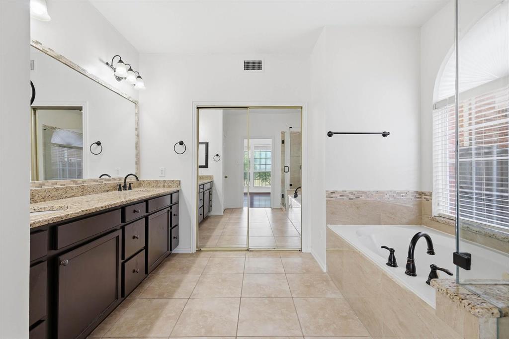 103 Ranch Trail Irving, TX 75063 - Photo 16 of 39 Ensuite has jetted garden tub with separate shower, dual sinks & granite tops.