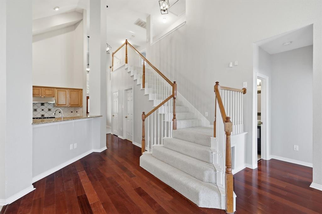 103 Ranch Trail Irving, TX 75063 - Photo 6 of 39 Impressive stairway with new carpet & freshly painted house. Nice wood flooring.