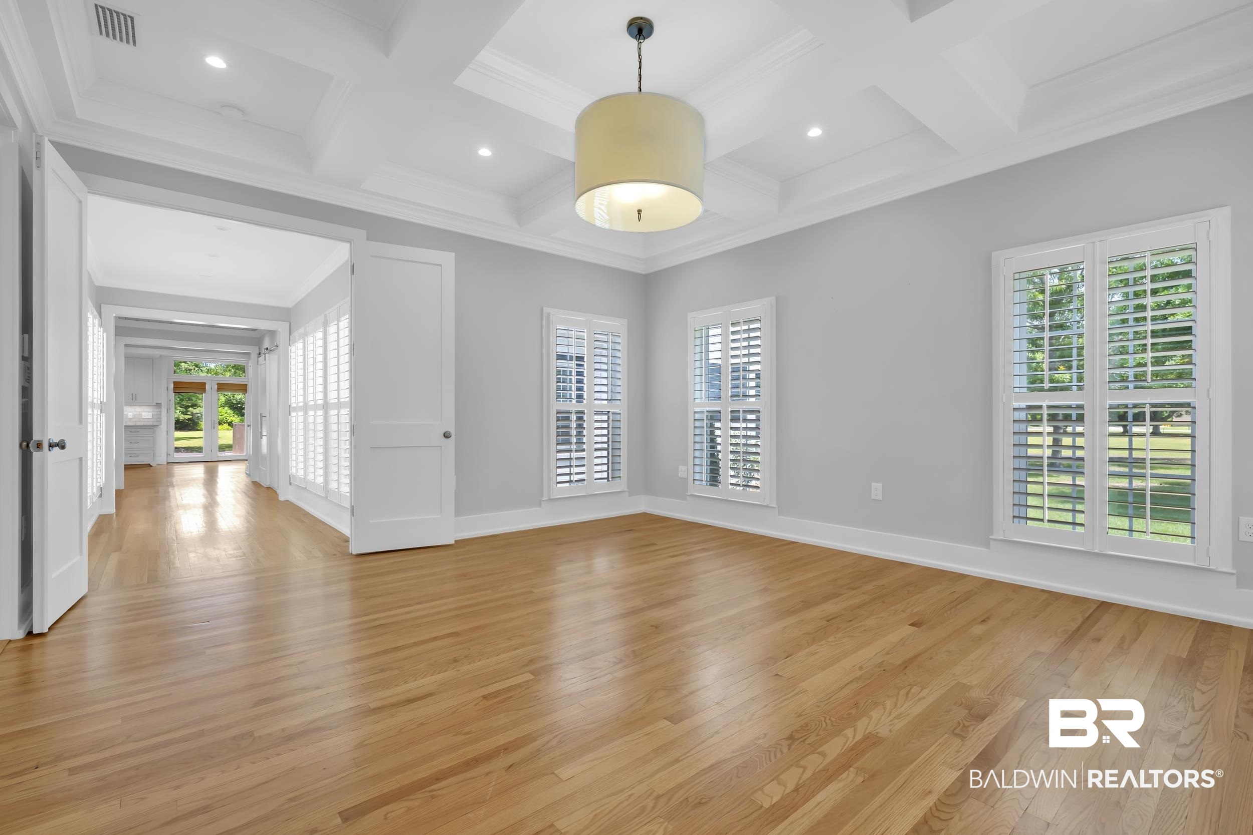 43199 Pine Grove Road Bay Minette, AL 36507 - Photo 51 of 71 Spacious room featuring wood-finish flooring, a coffered ceiling with recessed lighting, and a drum pendant light fixture