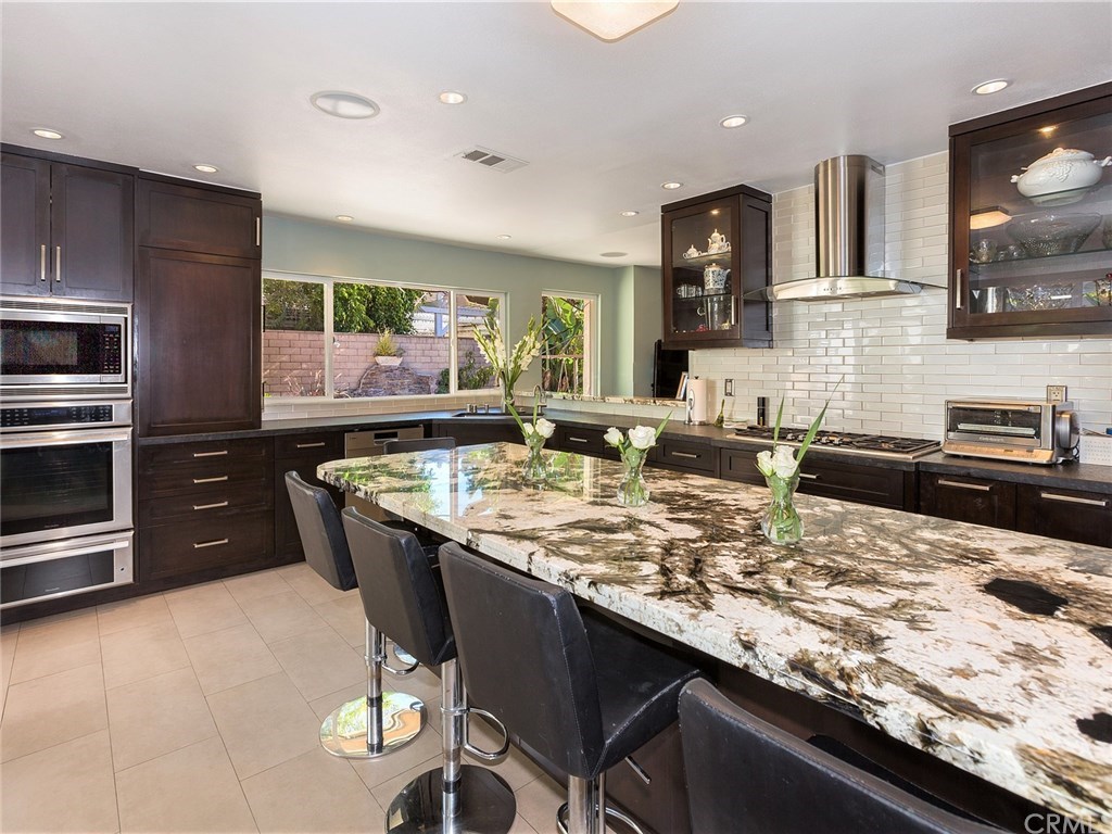 a kitchen with granite countertop a sink and cabinets